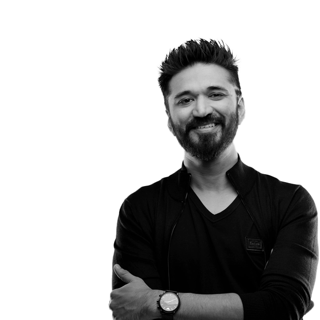 Amit Trivedi smiling, wearing a black shirt and a watch