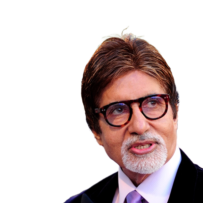 Amitabh Bachchan is wearing glasses and a suit.