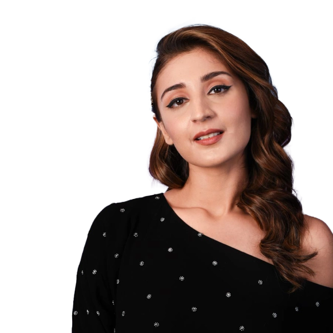 Dhwani Bhanushali in a black one-shoulder dress with soft curls and subtle makeup, posing against a dark background.