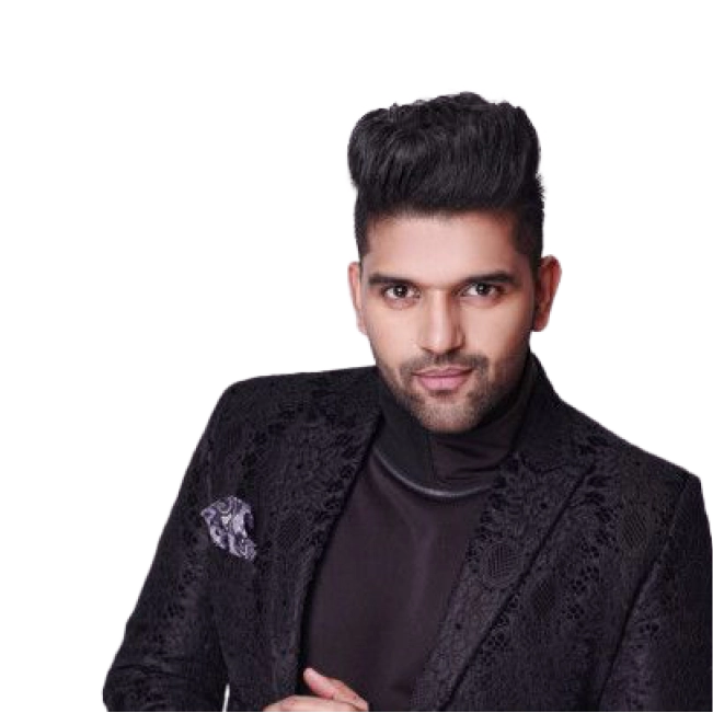 Guru Randhawa wearing a black textured suit with a broach.