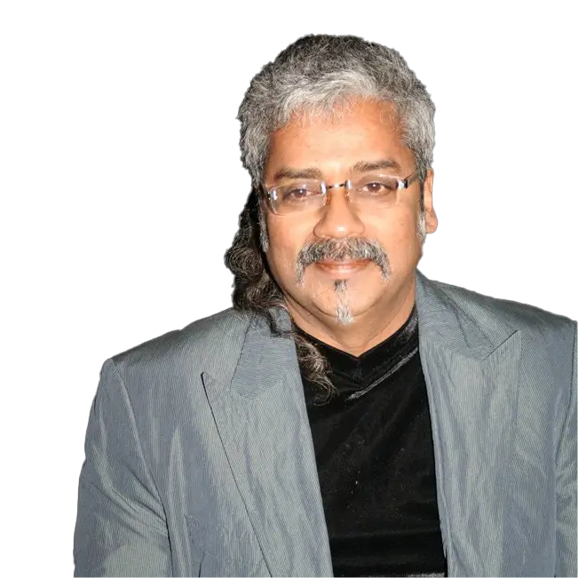 Hariharan wearing a grey suit and glasses, with grey hair and a mustache