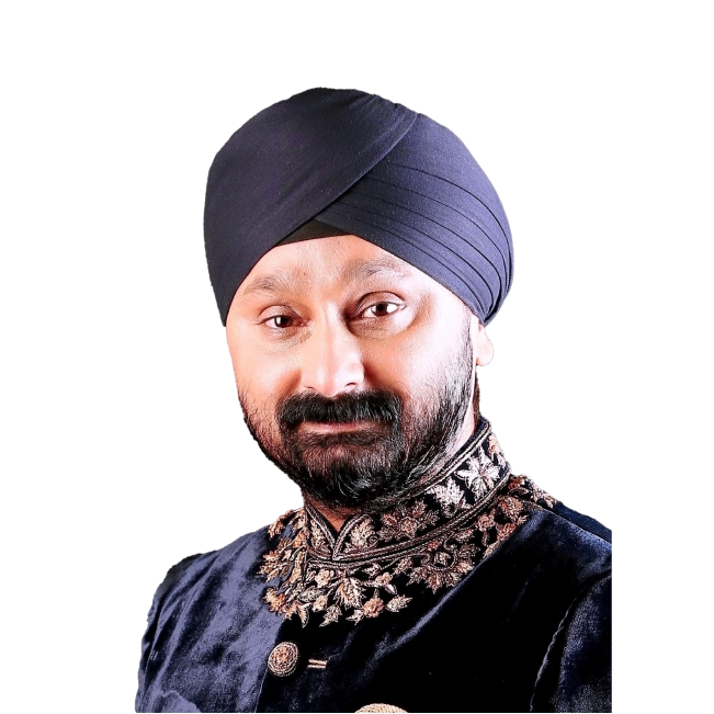 Jaswinder Singh wearing a traditional embroidered outfit and turban, smiling.