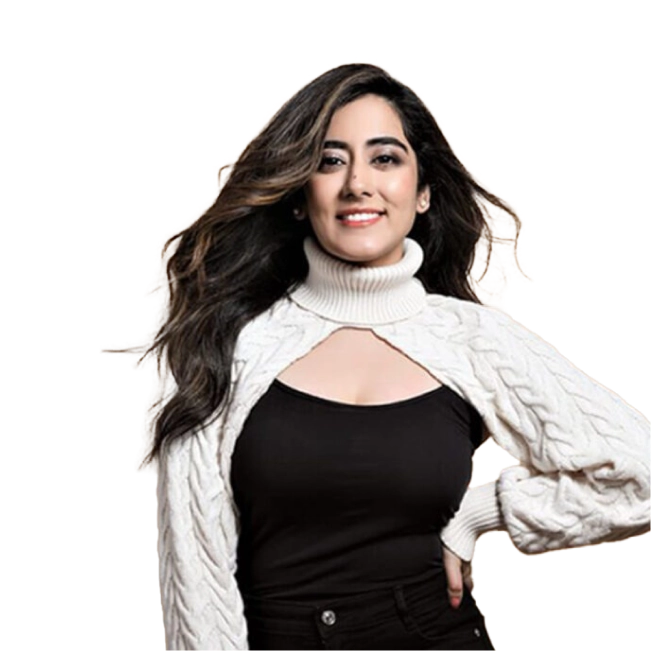 Jonita Gandhi wearing a white cable-knit sweater over a black top and smiling.