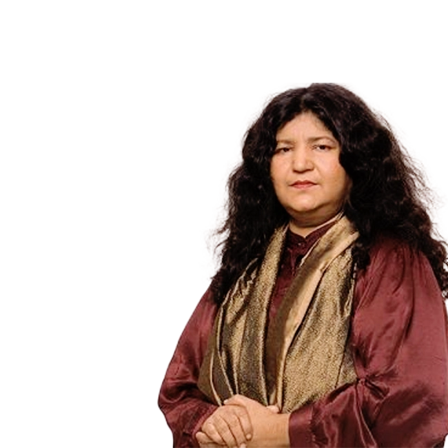 Abida Parveen, wearing a maroon traditional outfit with a gold scarf.