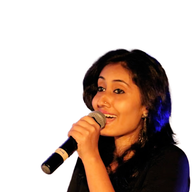 Aishwarya Ravichandran singing on stage with a mic.