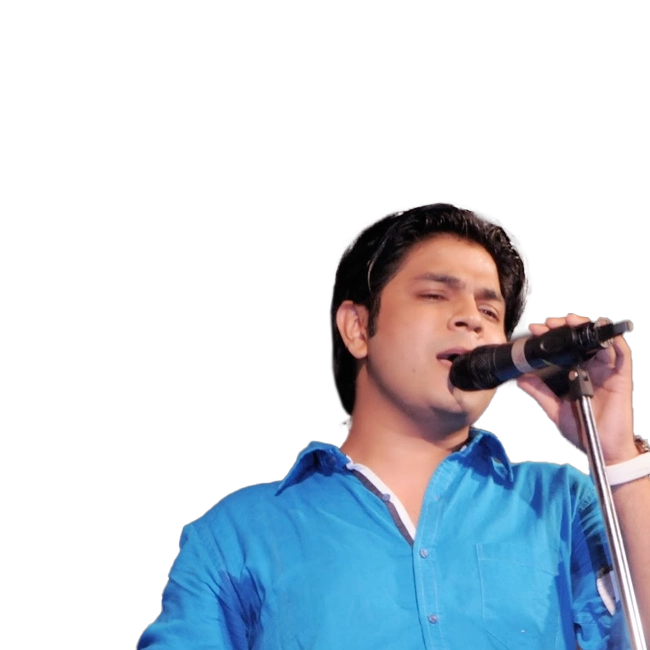 Ankit Tiwari singing into a microphone, wearing a blue shirt.