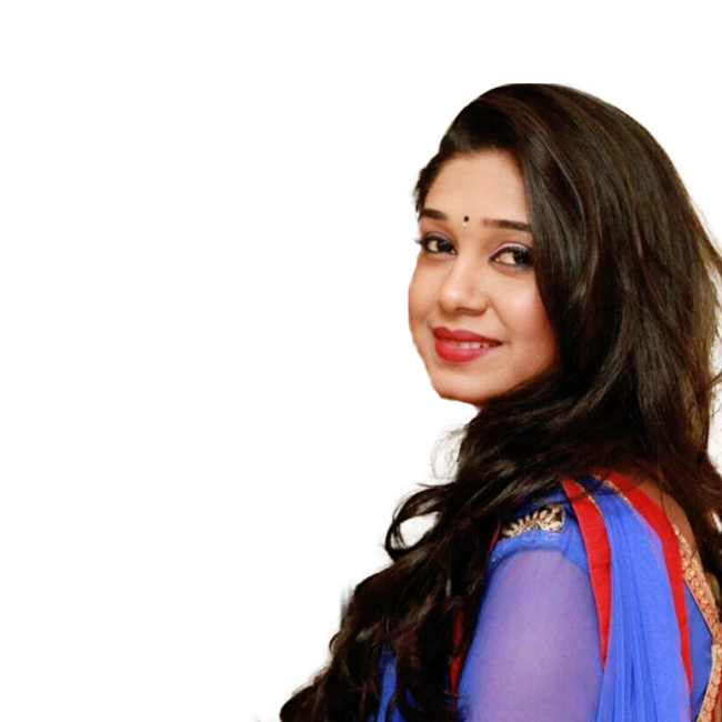 Antara Mitra, smiling while wearing a blue and red traditional outfit with long flowing hair.