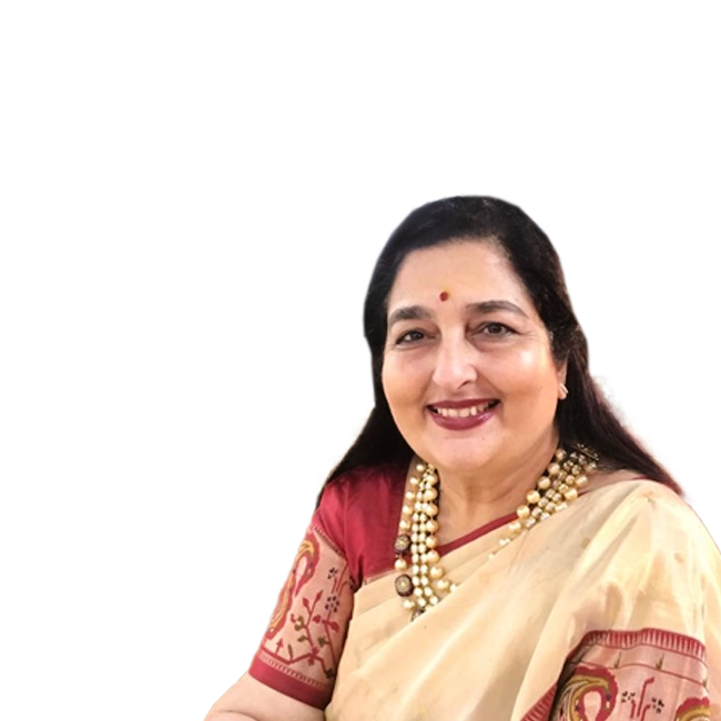 Anuradha Paudwal smiling, wearing a traditional saree and necklace.