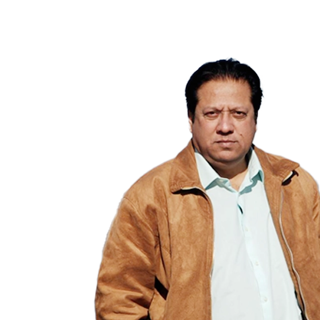 Arshad Mehmood in a light brown jacket and white shirt.