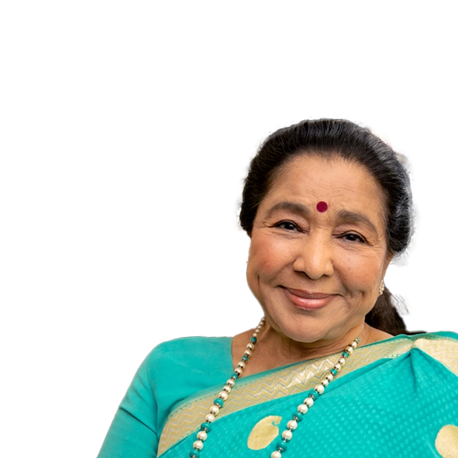 Asha Bhosle smiling, wearing a teal saree with a bindi on her forehead
