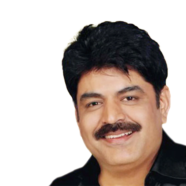 Babla Mehta, a smiling man with black hair and a moustache, wearing a black shirt