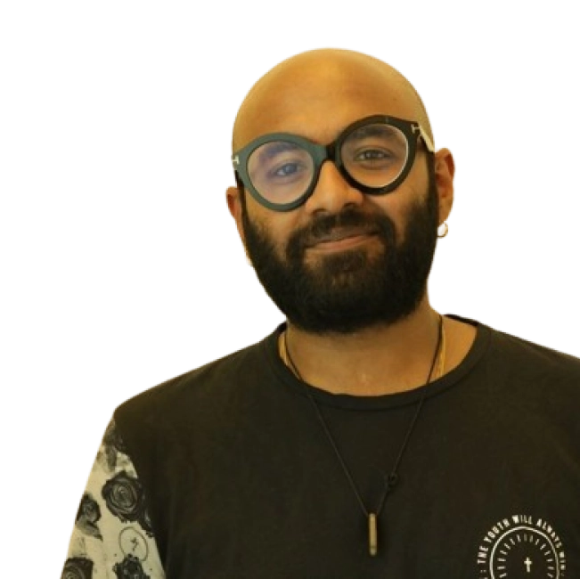 Singer Benny Dayal wearing glasses, a black t-shirt, and a necklace