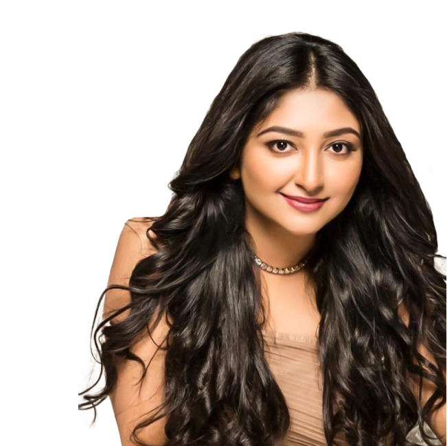 Bhoomi Trivedi with long wavy hair, wearing a beige top and a necklace.